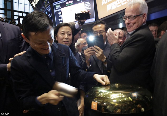 Welcome to Wall Street: Alibaba made $22billion by floating around 10 per cent of its stock on the NYSE this month. Ma is pictured above ringing the bell to start the trading